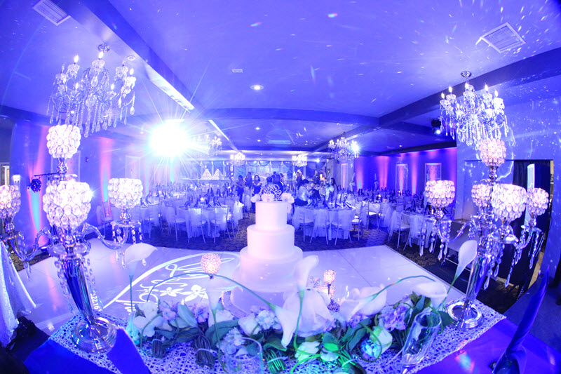 Asian Palace banquet hall set for a wedding reception with crystal centerpieces and a tiered wedding cake