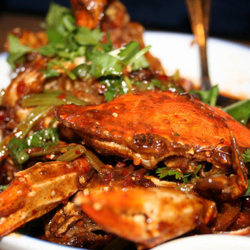 Spicy stir-fried crab with cilantro, served at Asian Palace